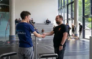 The moderation thanks a member of Team Spatzenhirn, after giving a technical presentation