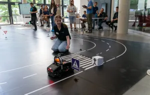 Spatz 11 waiting at a crosswalk for a pedestrian to pass